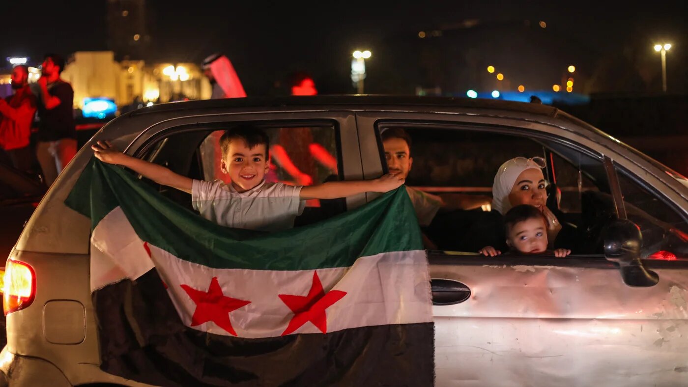 People celebrate in Damascus' Umayyad Square after US President Donald Trump's announcement that he would lift sanctions targeting Syria on 13 May 2025 (Abdulaziz Ketaz/AFP)