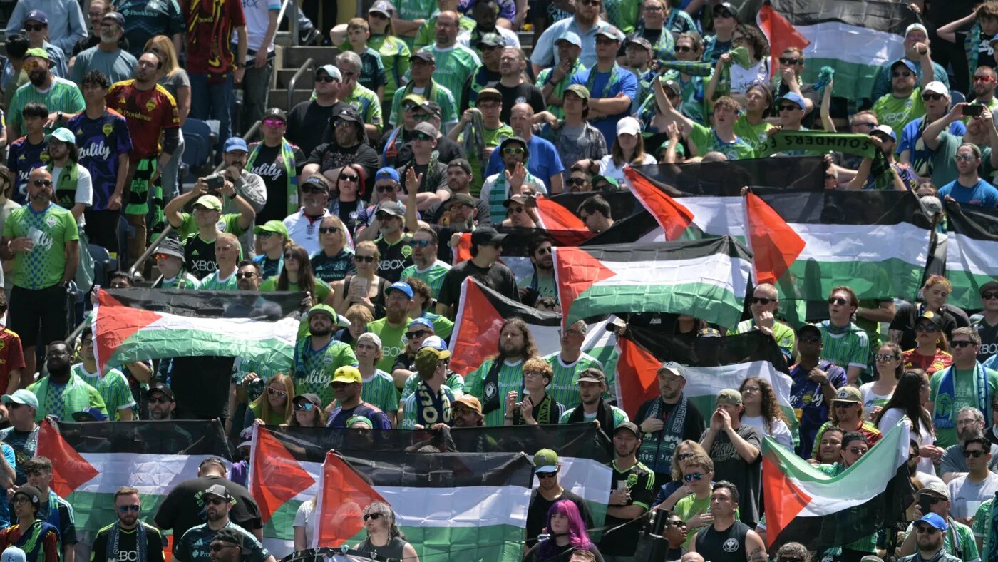 Fans hold Palestinian flags during the Fifa Club World Cup Group B match between Seattle Sounders and Paris Saint-Germain at Lumen Field stadium in Seattle, United States, on 23 June 2025 (Juan Mabromata/AFP)