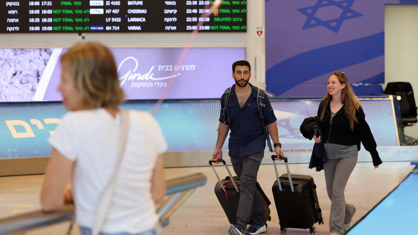 Incoming travellers walk with their luggage upon arrival at Israel's central Ben Gurion Airport on 25 June 2025 (Jack Guez/AFP)