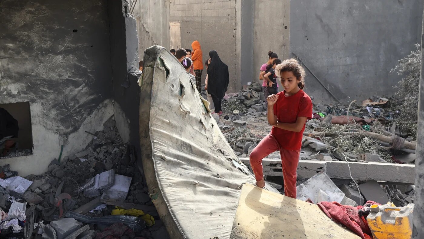 Palestinian children check the rubble of a residential house in Deir el-Balah in the central Gaza Strip on 1 July 2025, following overnight Israeli strikes (AFP/Eyad Baba)