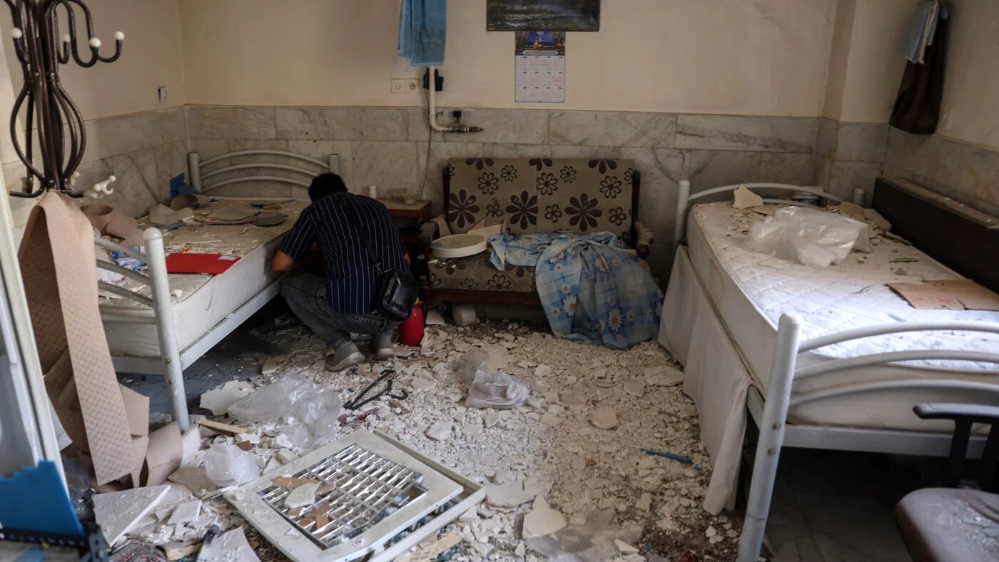 A man amid debris in a room in Evin prison's hospital after Israeli air strikes in Tehran on 1 July 2025 (AFP)