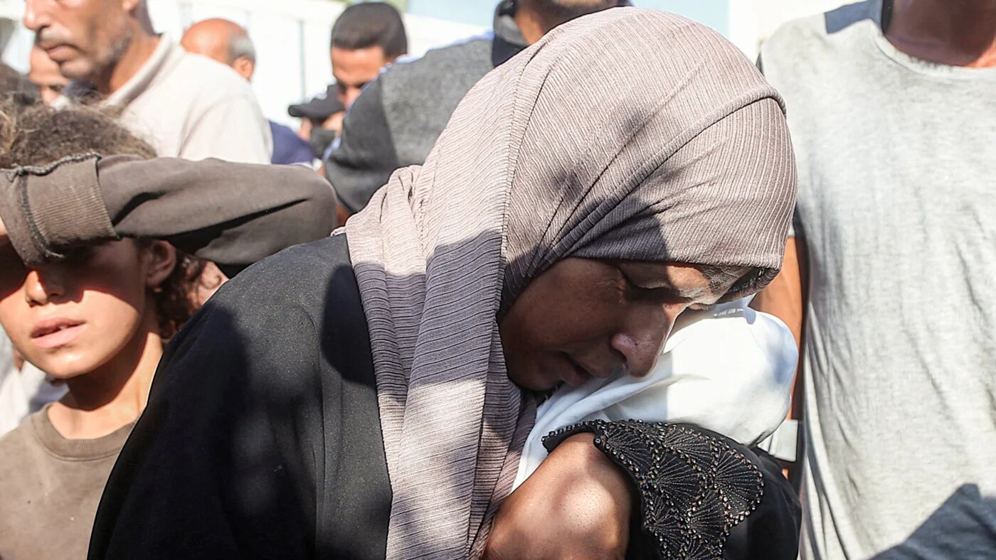 The mother of an infant who died due to malnourishment mourns as she holds his body at Nasser Medical Complex in Khan Yunis in the southern Gaza Strip on 20 July 2025 (AFP)