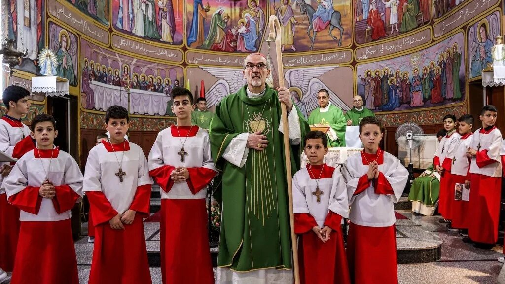 Cardinal Pierbattista Pizzaballa, Latin Patriarch of Jerusalem, stands with young altar servers during Sunday morning mass at the Roman Catholic Church of the Holy Family in Gaza City on July 20, 2025. (Omar Al Qattaa/AFP)