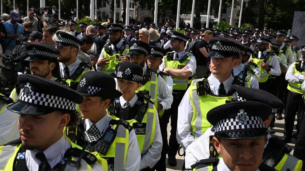 Members of the Metropolitan Police gather in Parliament Square ahead of a 'Lift The Ban' demonstration in central London, on 9 August 2025 (AFP)