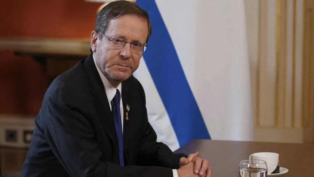 Israel's President Isaac Herzog sits at a table at the start of his meeting with Britain's Prime Minister Keir Starmer in 10 Downing Street in central London on September 10