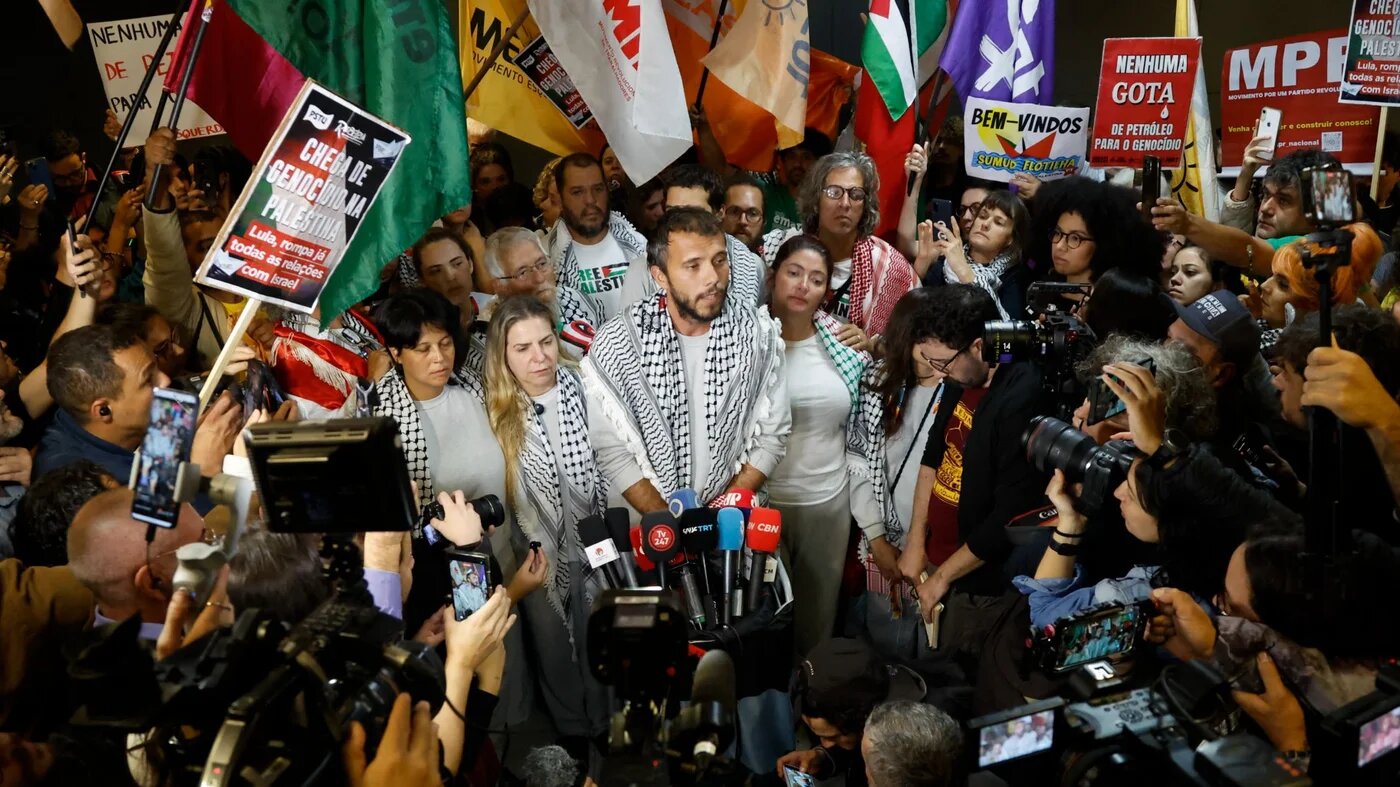 Global Sumud Flotilla activists speak to the media upon arriving at Guarulhos International Airport after being released by Israeli authorities, 9 October 2025 (Miguel Schincariol/AFP)
