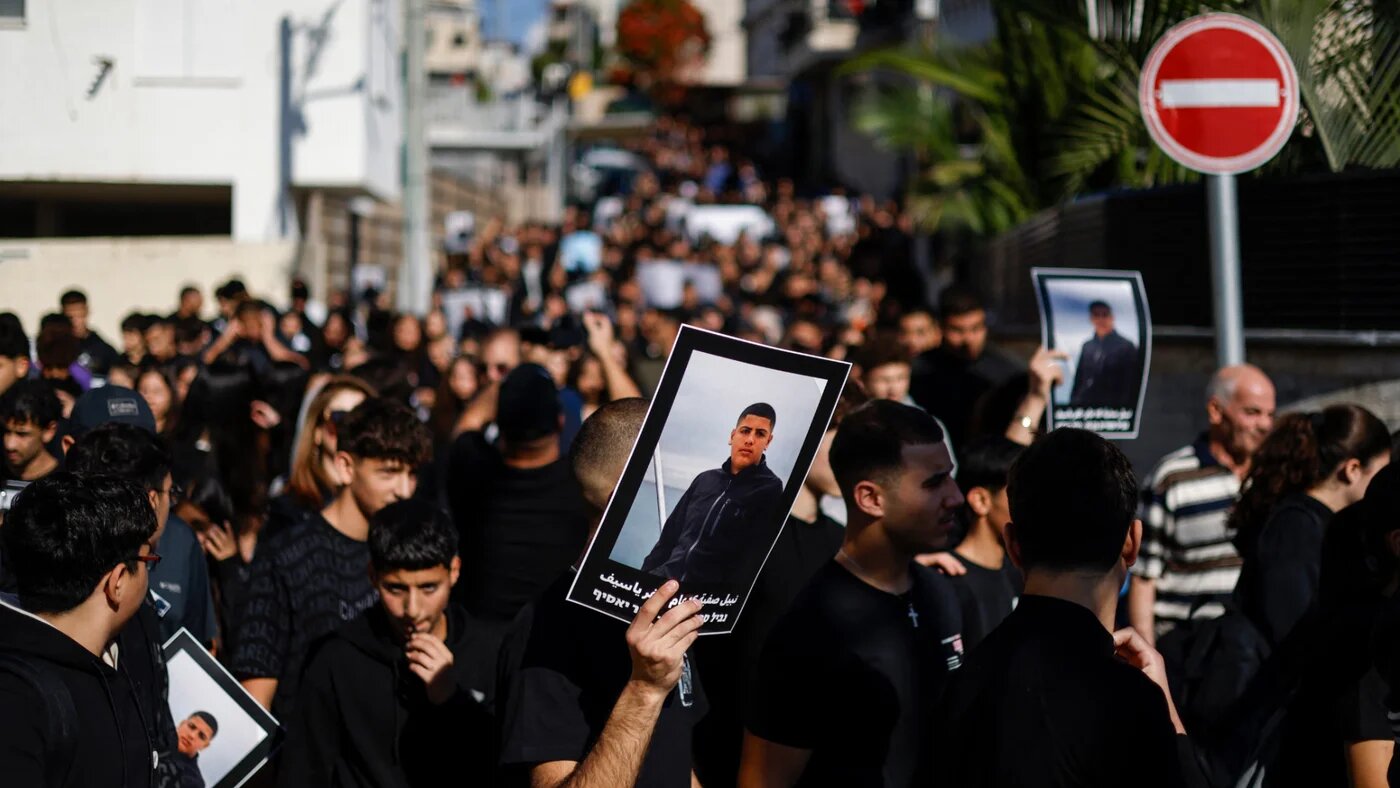 Palestinian residents of Kfar Yasif in Israel protest rising murders on 2 December 2025, holding posters of 16-year-old Nabil Safiyeh, killed last week (AFP/Jalaa Marey)