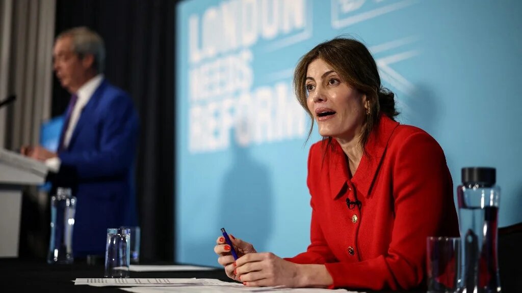 Westminster City councillor Laila Cunningham (R) attends a press conference with Reform UK leader Nigel Farage (back L) in London on January 7, 2026.