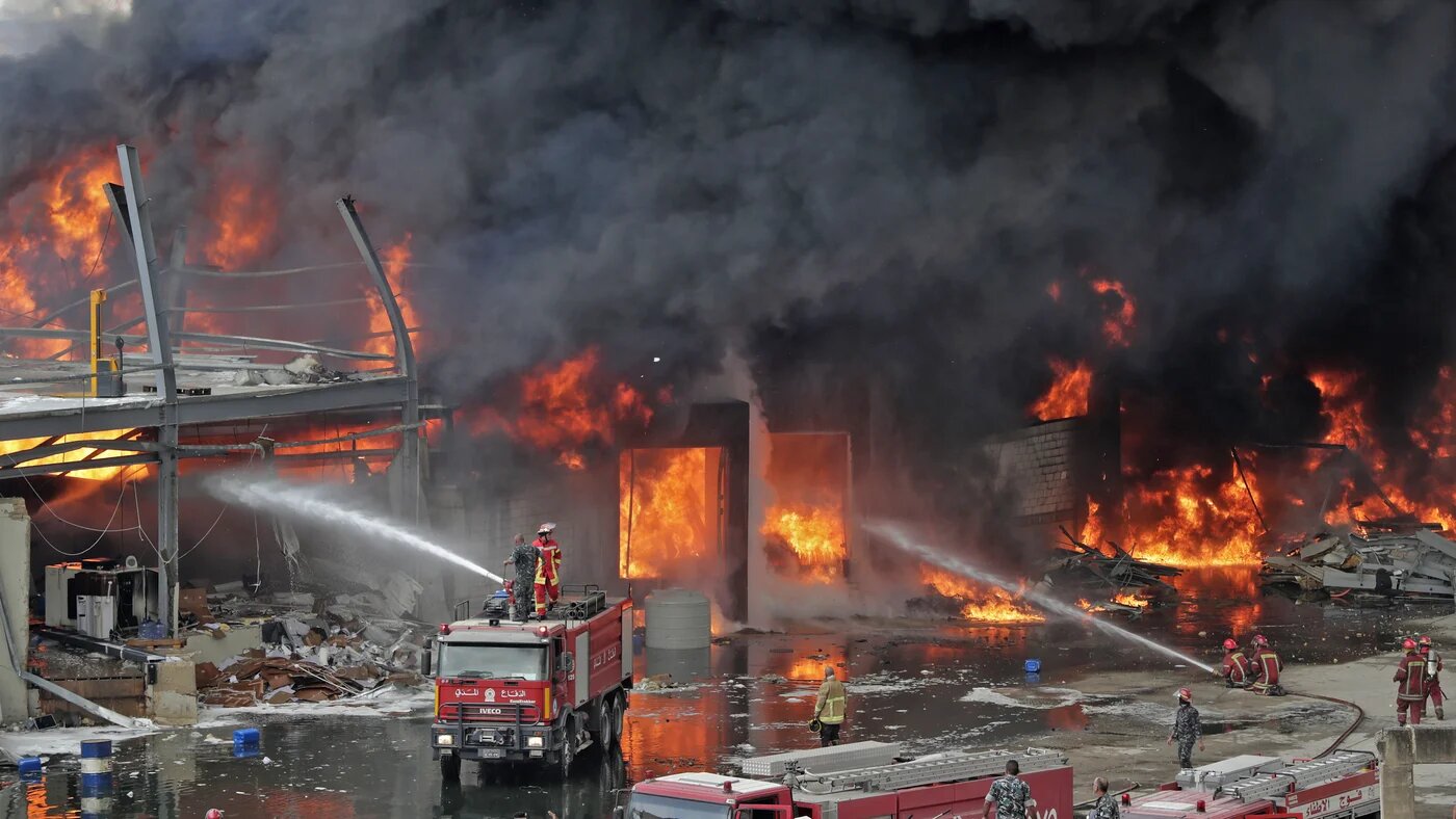 Lebanese firefighters try to put out a fire in Beirut's port area
