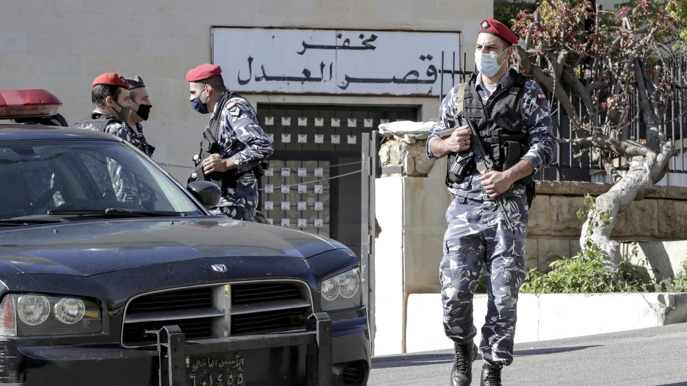 Police officers stand guard outside a detention centre outside Beirut
