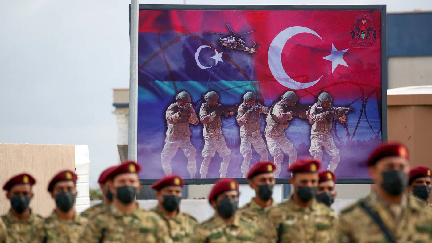 Libyan military graduates loyal to the UN-recognised Government of National Accord (GNA) take part in a parade marking their graduation, a result of a military training agreement with Turkey, at the Omar Mukhtar camp in the city of Tajoura, southeast of the capital Tripoli on 21 November, 2020. (AFP)