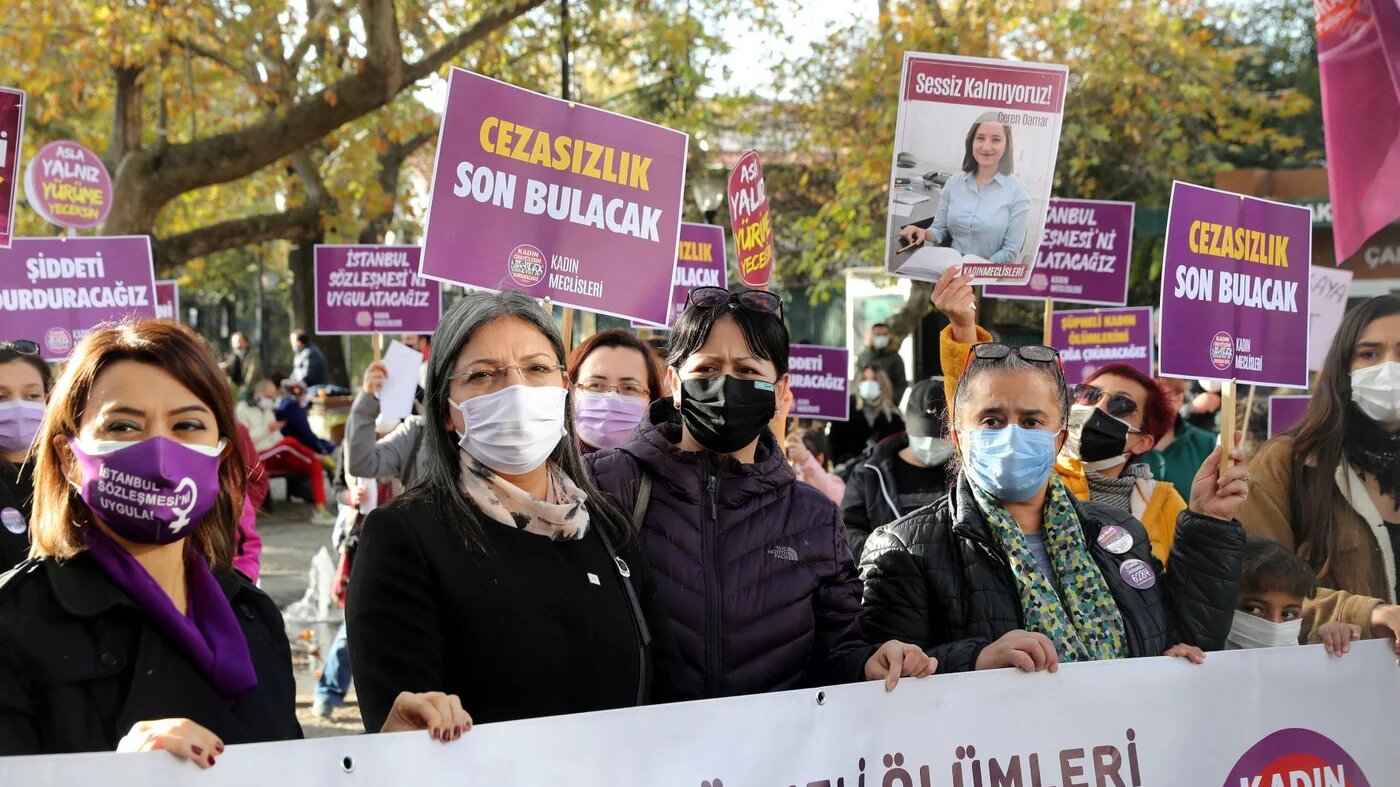 Members of We Will Stop Femicides Platform hold placards reading 'stop femicide' and 'We will enforce the Istanbul convention', during a protest for a better implementation of the Istanbul Convention and the Turkish Law 6284 for protection of the family and prevention of violence against women (AFP)