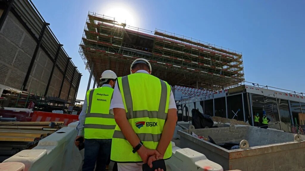 Construction workers on the site of the French Expo 2022 pavilion building in Dubai 