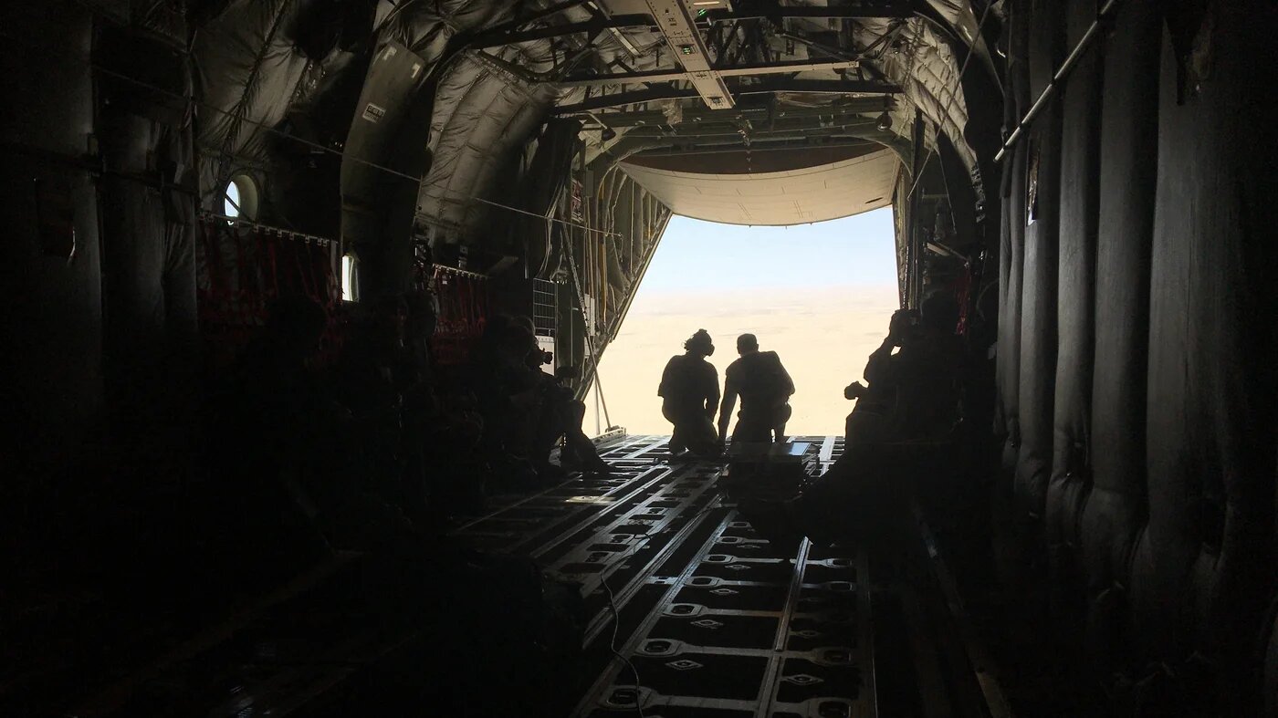 French Prime Minister Jean Castex (R) looks outside a plane flying towards Faya Largeau, Chad, on December 31, 2020, after spending the New Year's Eve with French troops serving in the counter-terrorism 'Barkhane' force deployed in Sahel. Jérémy MAROT / AFP