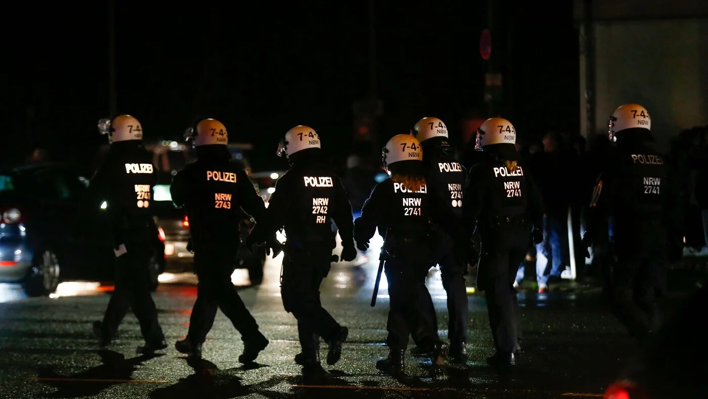 Police move in on Essen fans celebrating with flares after the German Cup (DFB Pokal) last 16 football match Rot-Weiss Essen v Bayer Leverkusen in Essen, western Germany on February 2, 2021 (AFP)