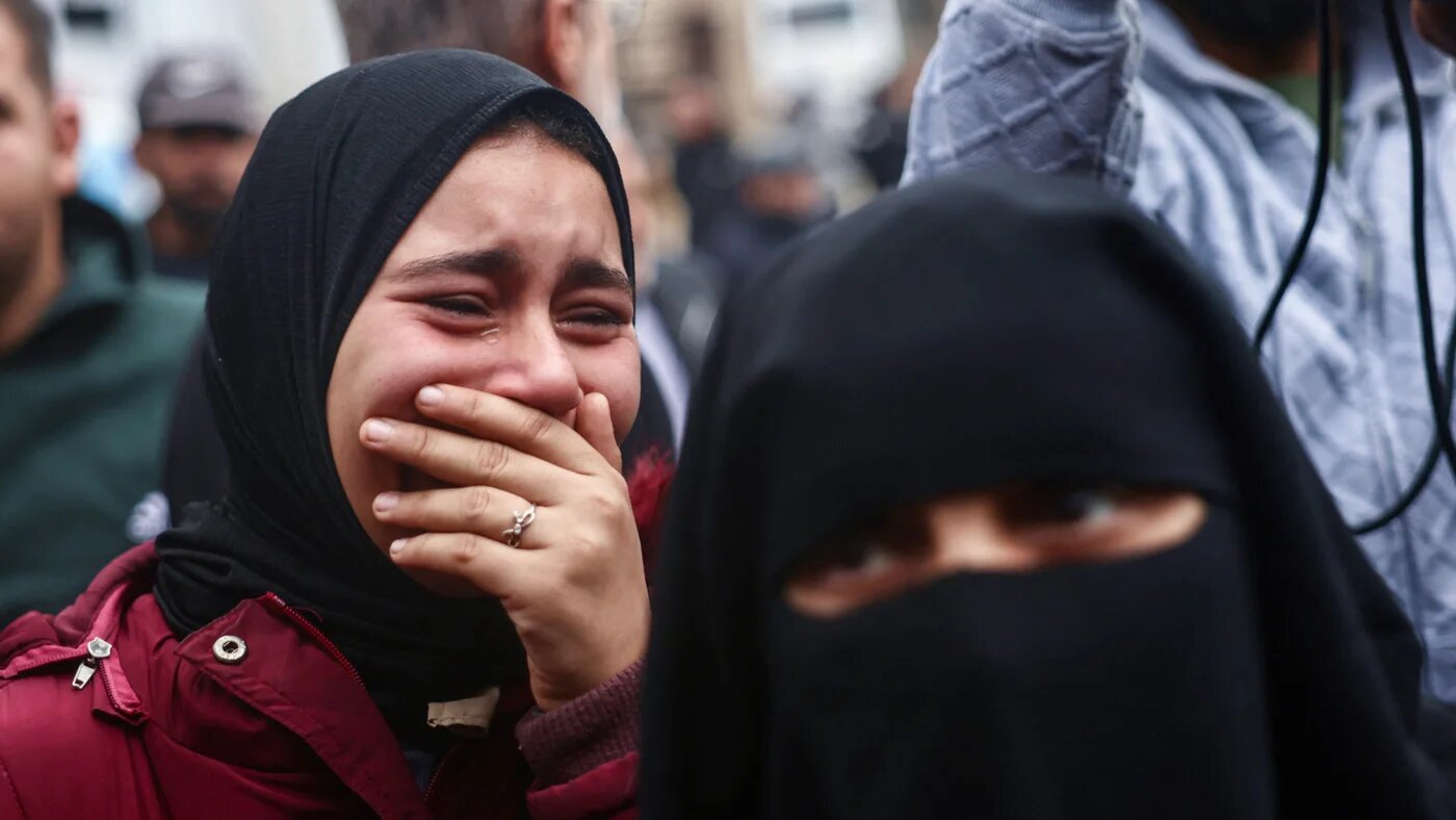 A Palestinian woman cries as families collect the bodies of relatives killed in Israeli shelling at Nasser Hospital in Khan Younis, southern Gaza, on 9 January 2026 (AFP/Bashar Taleb)