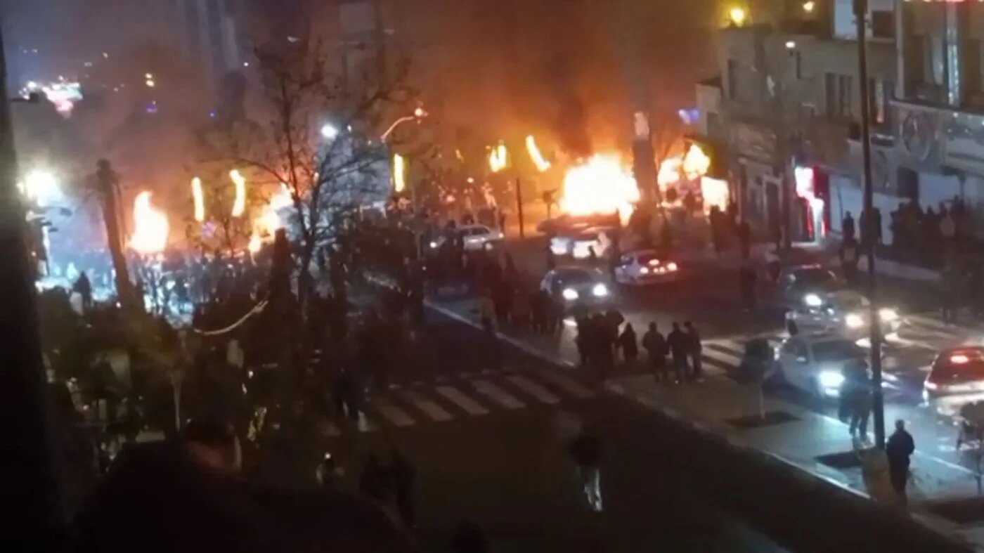 This video grab taken from UGC images posted on social media on 9 January 2026 shows cars set on fire during a protest on Saadat Abad Square in Tehran (AFP)