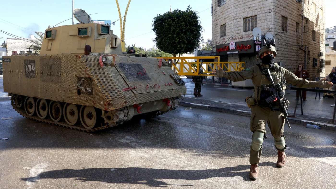 An Israeli soldier reacts as the military closes part of the southern sector of the West Bank city of Hebron in the occupied West Bank on 19 January 2026 (AFP/Hazem Bader)