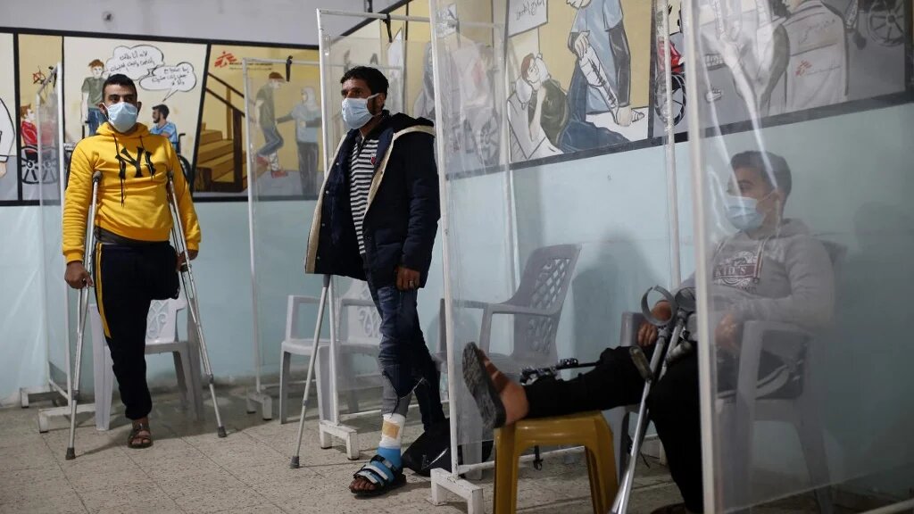 Palestinians wait for their turn at a clinic run by medical charity Doctors Without Borders (MSF) in Gaza City on 22 February 2021 (AFP)
