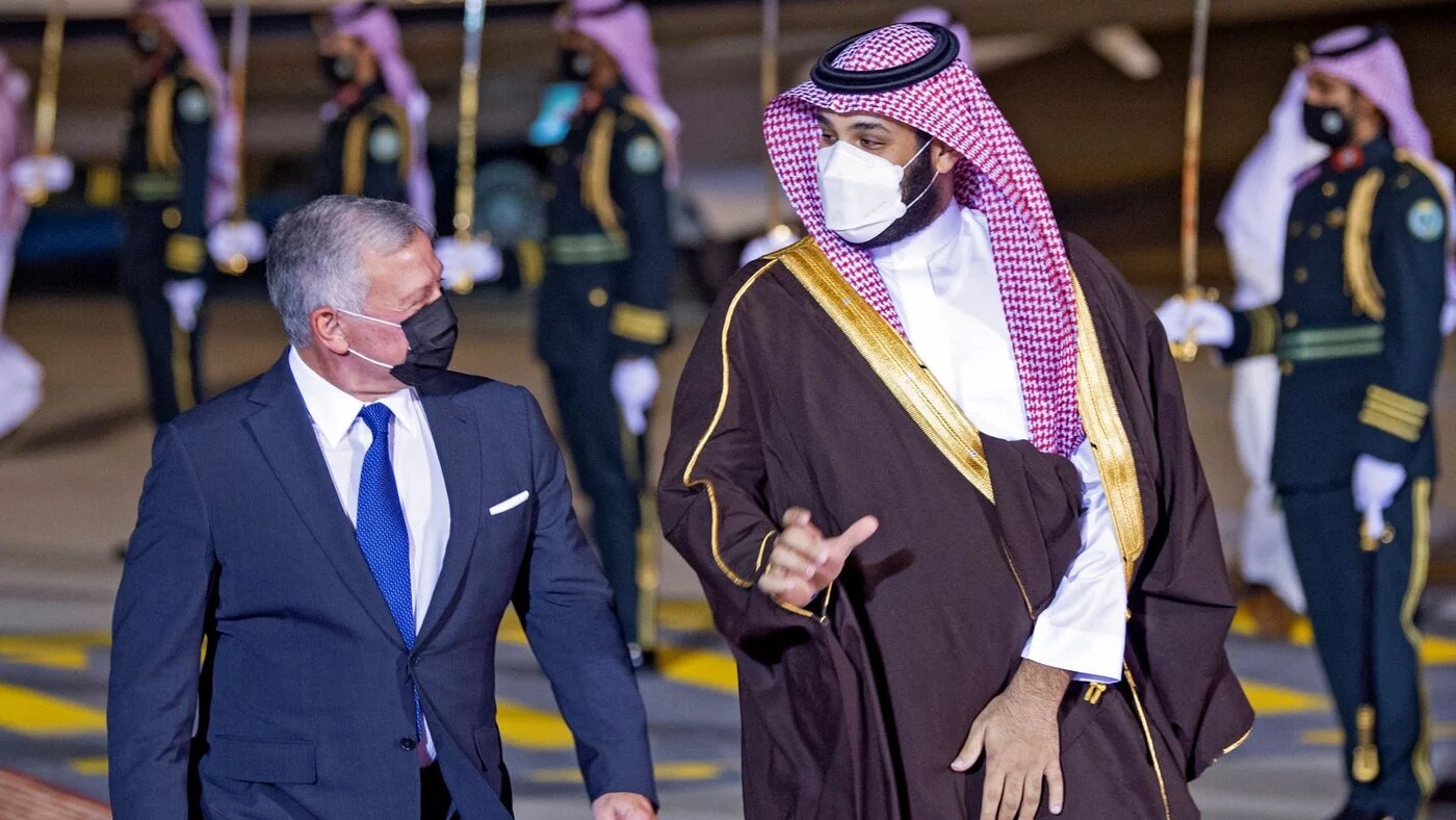 A handout picture provided by the Saudi Royal Palace on March 8, 2021, shows Crown Prince Mohammed bin Salman welcoming Jordan's King Abdullah II (L) upon his arrival in the capital Riyadh (AFP)