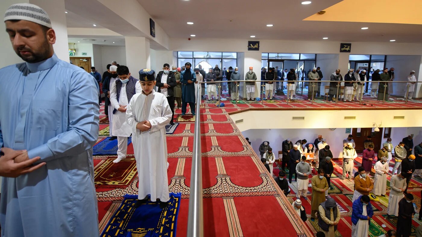 Muslims gather to perform the Eid al-Fitr prayer, which marks the end of the holy month of Ramadan, at Bradford Central Mosque, northern England, on 13 May 2021 (AFP)
