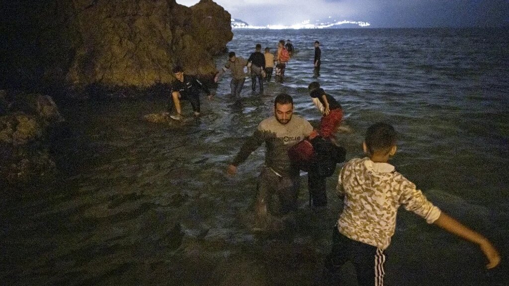 Des migrants marocains tentent de traverser la frontière entre le Maroc et l’enclave nord-africaine espagnole de Ceuta, le 18 mai 2021 (AFP)