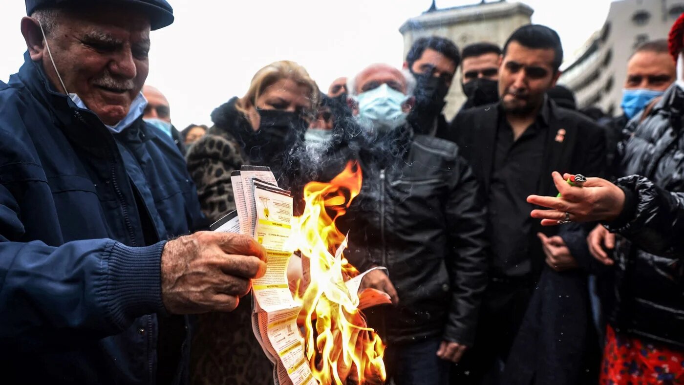People burn their electricity bills as a protest against high energy prices in on February 9, 2022 (AFP)