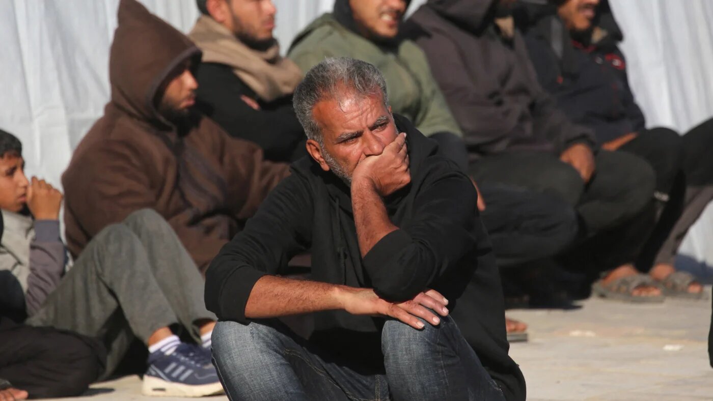 A man sits watching as family members mourn outside the Nasser Hospital, the day after a Palestinian was killed in an Israeli strike in Khan Yunis, in the southern Gaza Strip on 10 April 2026 (AFP/Bashar Taleb)
