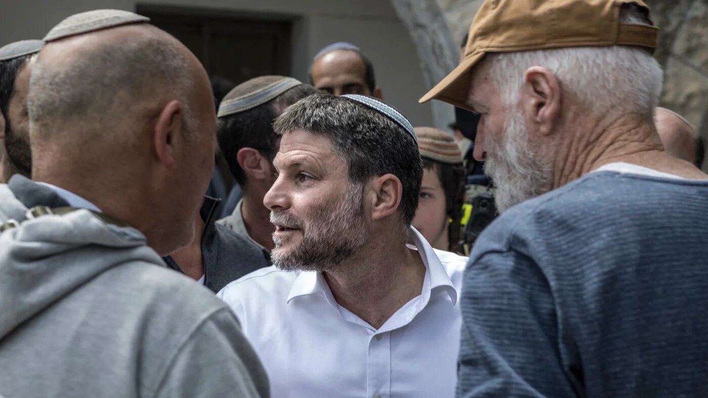 Israel's Finance Minister Bezalel Smotrich is surrounded by  settlers at the end of the resettlement ceremony of Sa-Nur, south of Jenin, in the occupied West Bank on 19 April 2026 (Marco Longari/AFP)