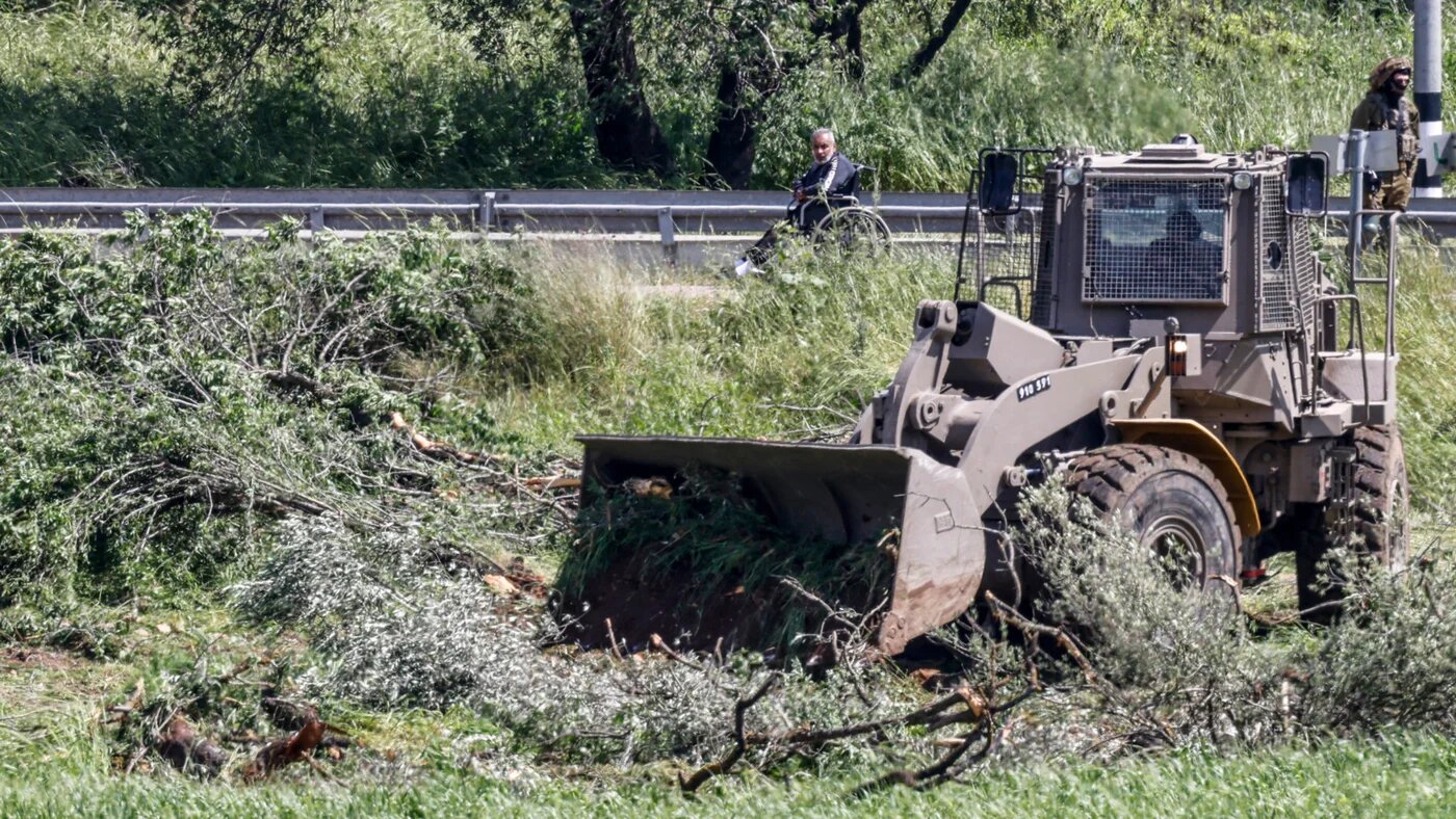 Israeli bulldozer uproots olive trees in the village of Al-Lubban ash-Sharqiya, south of Nablus in the occupied west bank, on 20 April 2026 (Zain Jaafar/AFP)