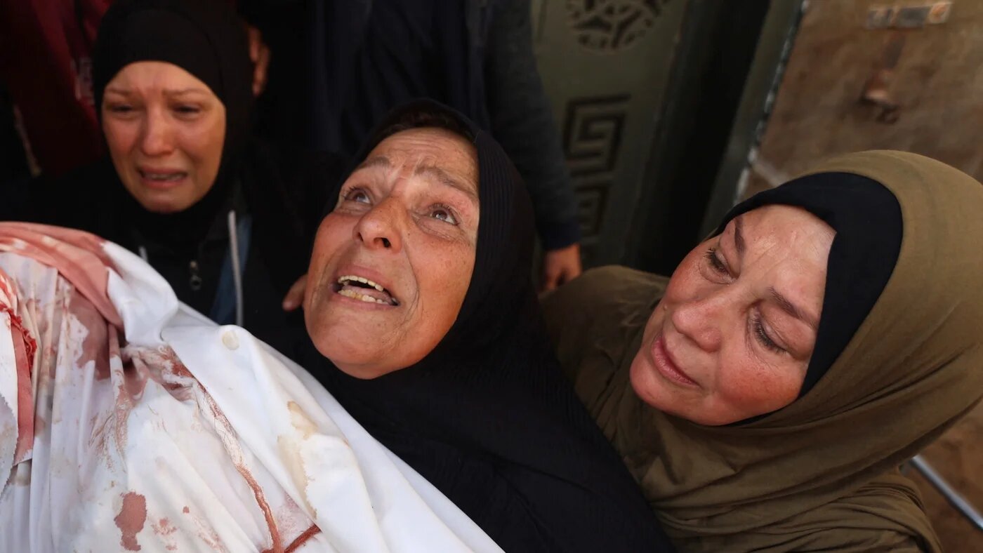 Mourners weep beside the body of a child at a hospital in Gaza City on 25 April 2026, after Israeli artillery struck homes near Kamal Adwan Hospital in Beit Lahia, killing a woman and her two children (Omar al-Qattaa/AFP)