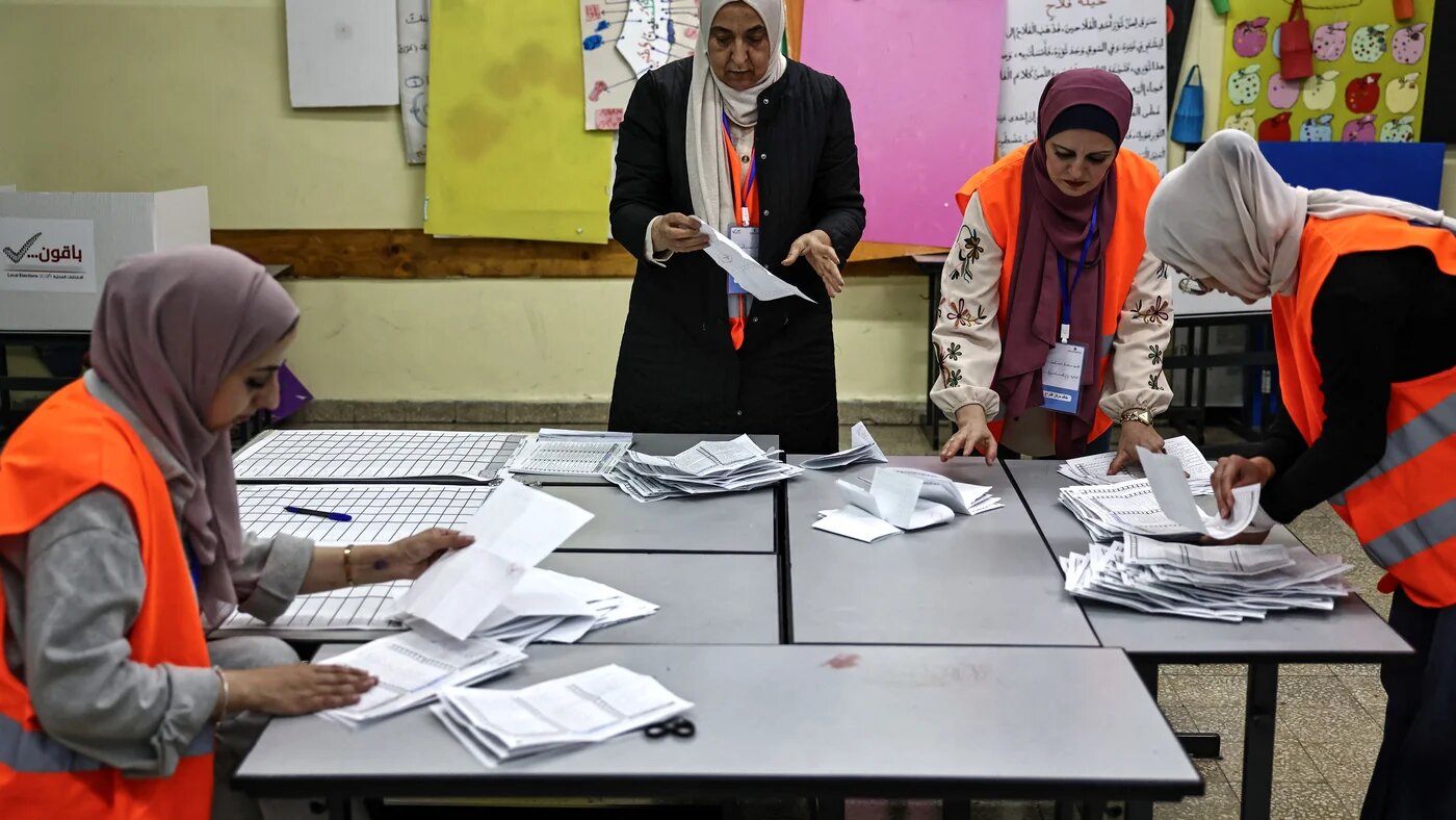 Palestinian electoral employees begin counting votes after polls closed in municipal elections in al-Bireh, occupied West Bank, on 25 April 2026 (Zain Jaafar/AFP)