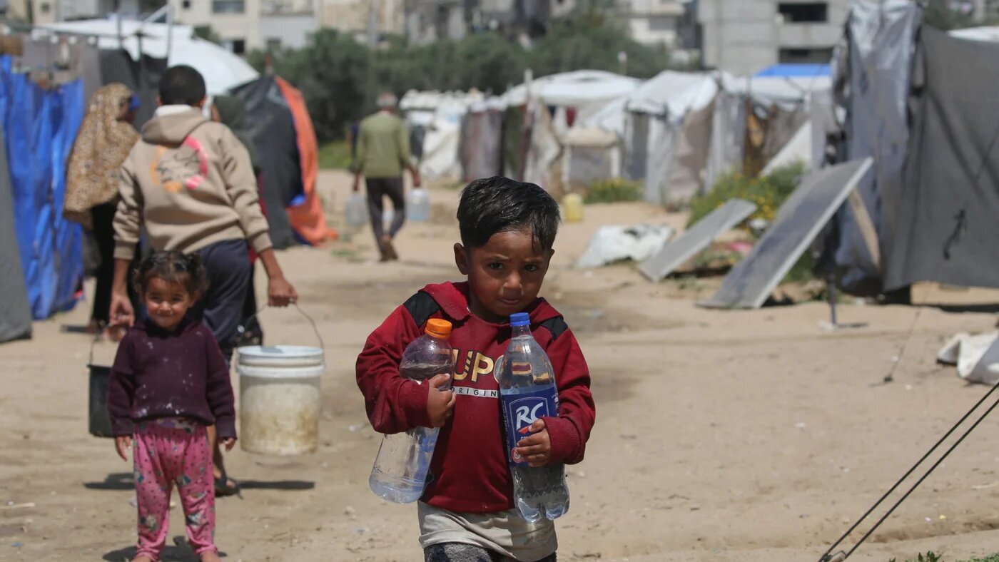 Children fetch drinking water at the Bureij refugee camp in the central Gaza Strip on 28 April 2026, as most of Gaza's 2.4 million people remain displaced, many of them repeatedly (Eyad Baba/AFP)