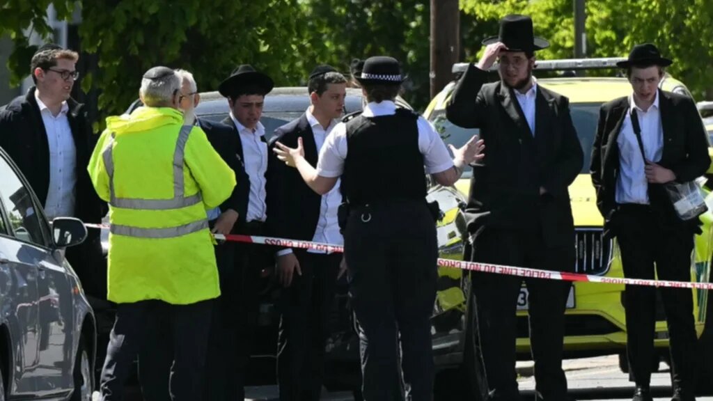 Local residents look on from outside a cordoned off area in the Golders Green neighbourhood of north London on April 29, 2026