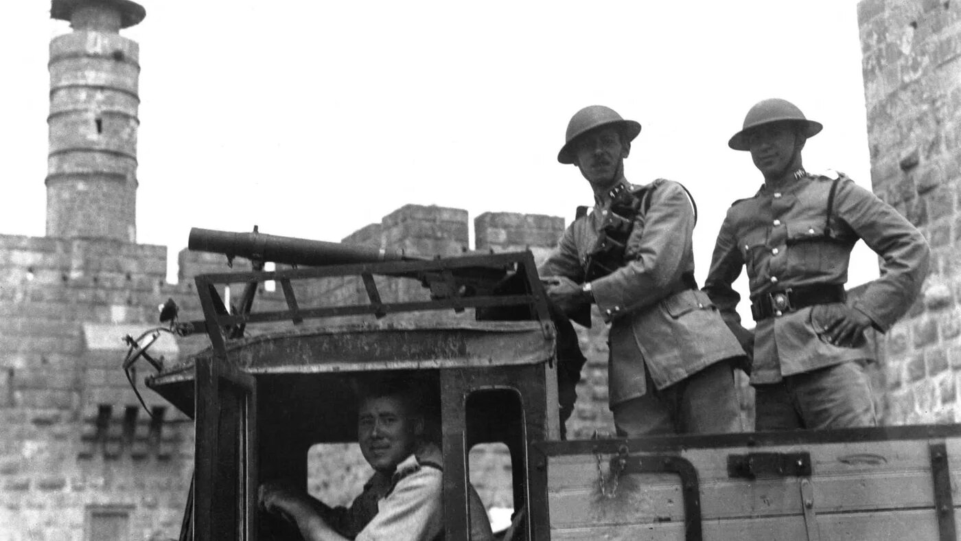 A picture released 10 June 1936 shows armed British soldiers aboard a British military vehicule with a Lewis machine-gun as it passes the citadel in Jerusalem during the British Mandate in Palestine (AFP)