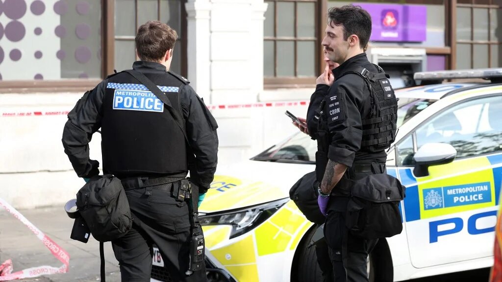 Police from the Counter Terrorism Policing (CTP) Chemical, Biological, Radiological, or Nuclear materials (CBRN) unit, along with Fire and Ambulance Emergency services, work at the site of an incident outside a Natwest Bank on Golders Green Road in north west London on May 8, 2026.