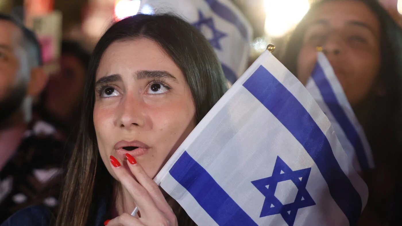A woman reacts as people gather at the Tel Aviv 360, a giant beachfront stage in Tel Aviv on 16 May 2026, to watch the final of the Eurovision Song Contest 2026 (Jack Guez/AFP)