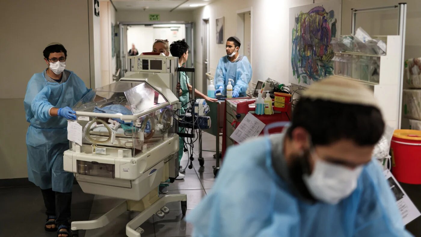 Hospital staff move a baby in an incubator to an underground facility for safety in Tel Aviv on 8 June 2026, after sirens sounded following Iranian attacks (Ilia Yefimovich/AFP)