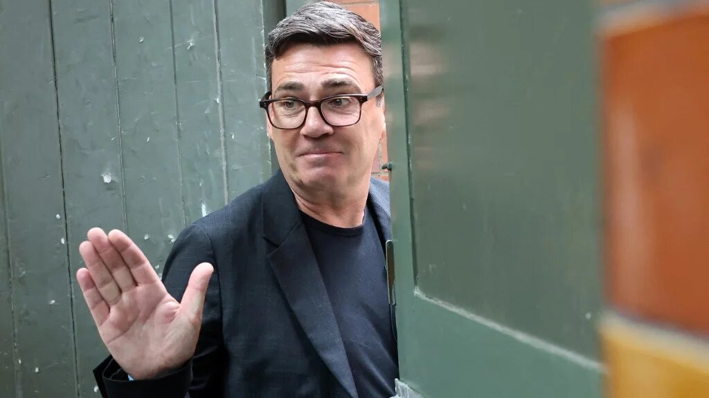 Labour MP and challenger for Leader of the Labour party, Andy Burnham, waves as he leaves after delivering a speech in Manchester, northern England, on June 29, 2026.