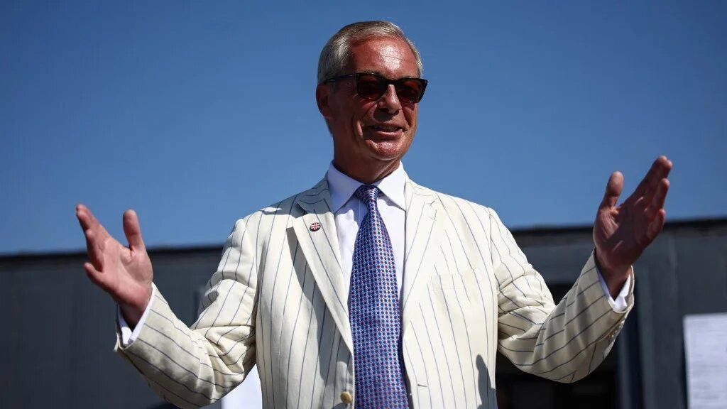 Reform UK leader Nigel Farage arrives to vote in the Clacton by-election, at a makeshift polling station in a primary school in Walton-on-the-Naze, Essex on August 13, 2026. 