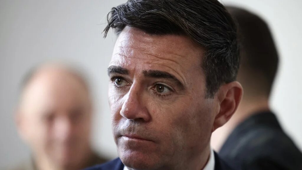 Britain's prime minister Andy Burnham looks on as he listens to hospital senior staff members upon arrival at the Main Military Hospital, supported by the David Nott Foundation, a UK charity who have trained over 1,000 Ukrainian surgeons, anaesthetists and other healthcare workers, in Kyiv on August 24, 2026.