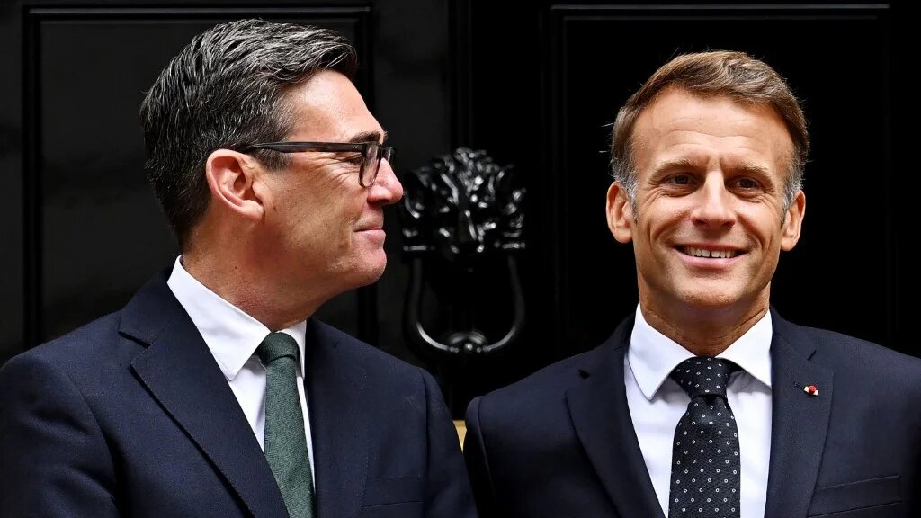 Britain's Prime Minister Andy Burnham (L) looks at France's President Emmanuel Macron as they pose for photos ahead of a bilateral meeting at 10 Downing Street in central London on September 3, 2026.