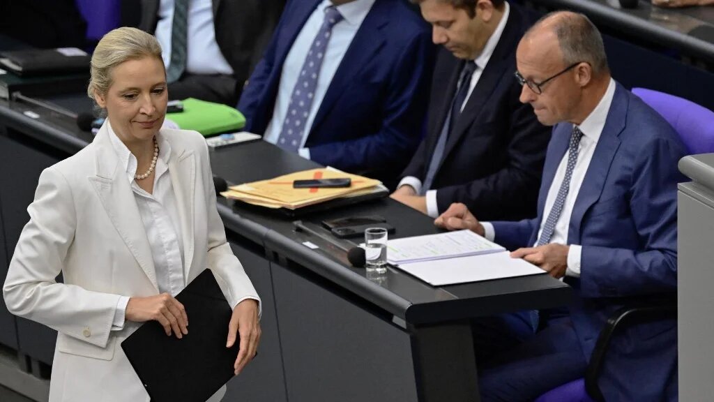 Alice Weidel of the AfD walks past German Chancellor Friedrich Merz at the Bundestag, Berlin, on 9 September 2026 (John MacDougall/AFP)