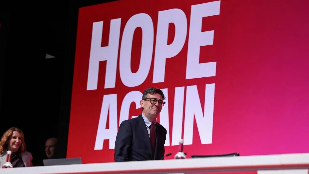 Britain's Prime Minister Andy Burnham (C) walks onto the stage with Britain's First Secretary of State Louise Haigh (far L) ahead of her speech on the first day of the annual Labour Party conference in Liverpool, north-west England, on September 27, 2026.