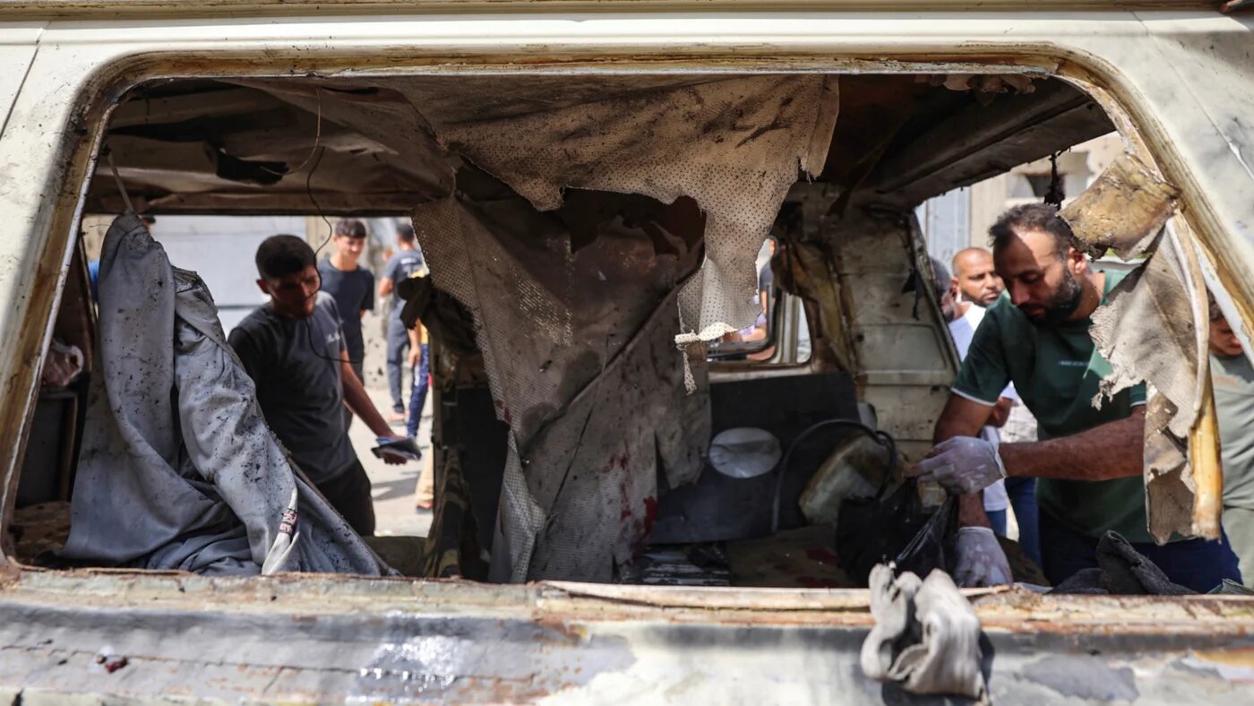 Palestinians inspect the damage following an Israeli airstrike that targeted a minibus and killed five people in Gaza City's Tel al-Hawa neighbourhood on 30 September 2026 (Omar al-Qattaa/AFP)