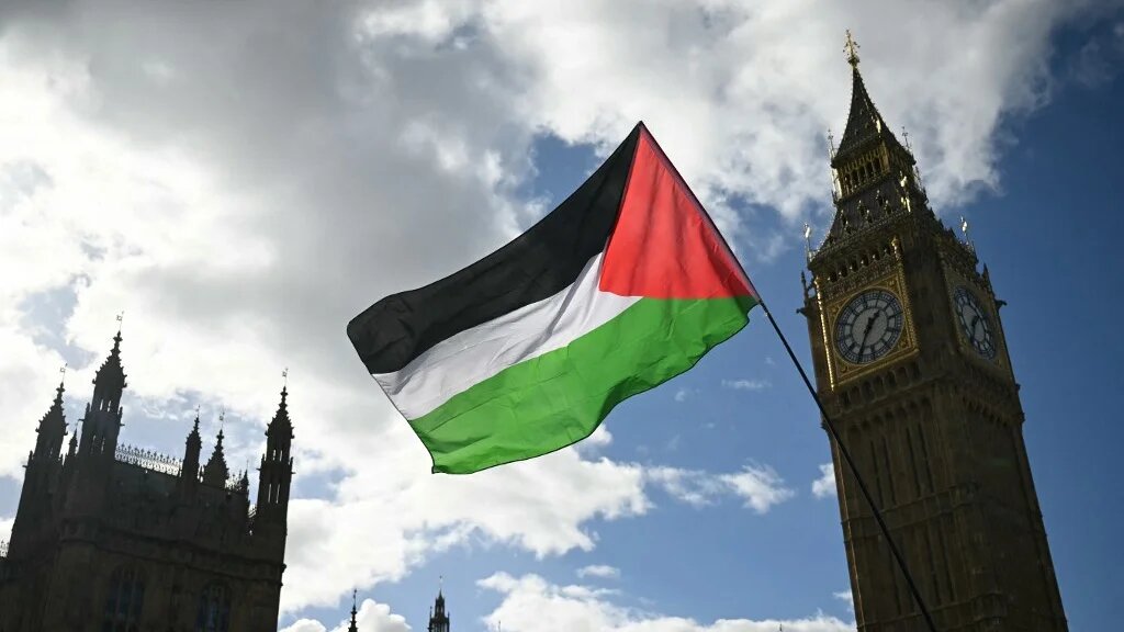 A Palestinian flag flutters in the breeze beside the Palace of Westminster as a National March in support of Palestine, organised by Palestine Solidarity Campaign, passes by, in central London on October 10, 2026.