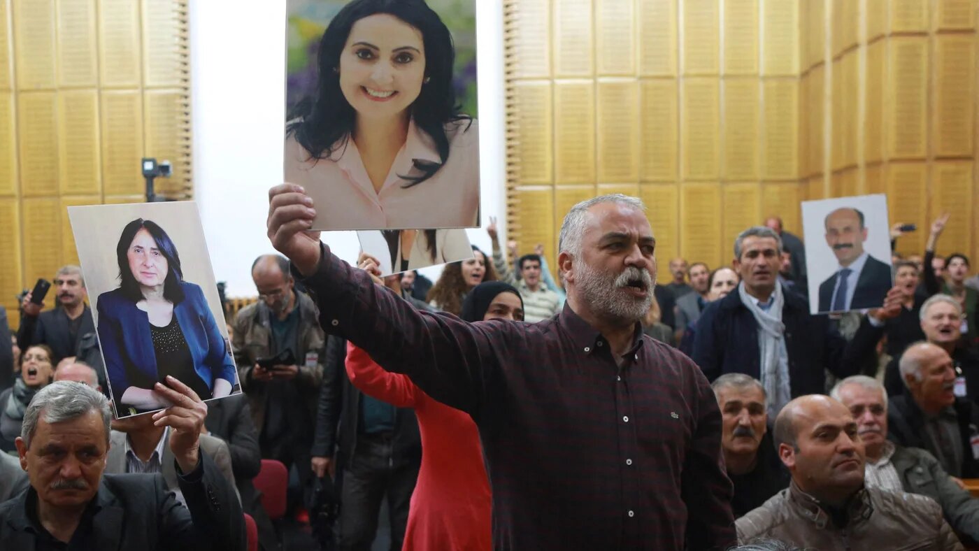 A supporter holds a portrait of Figen Yuksekdag, detained co-leader of Turkey's pro-Kurdish opposition Peoples' Democratic Party (HDP) at a meeting at the Turkish parliament in Ankara, on November 8, 2016 (AFP)
