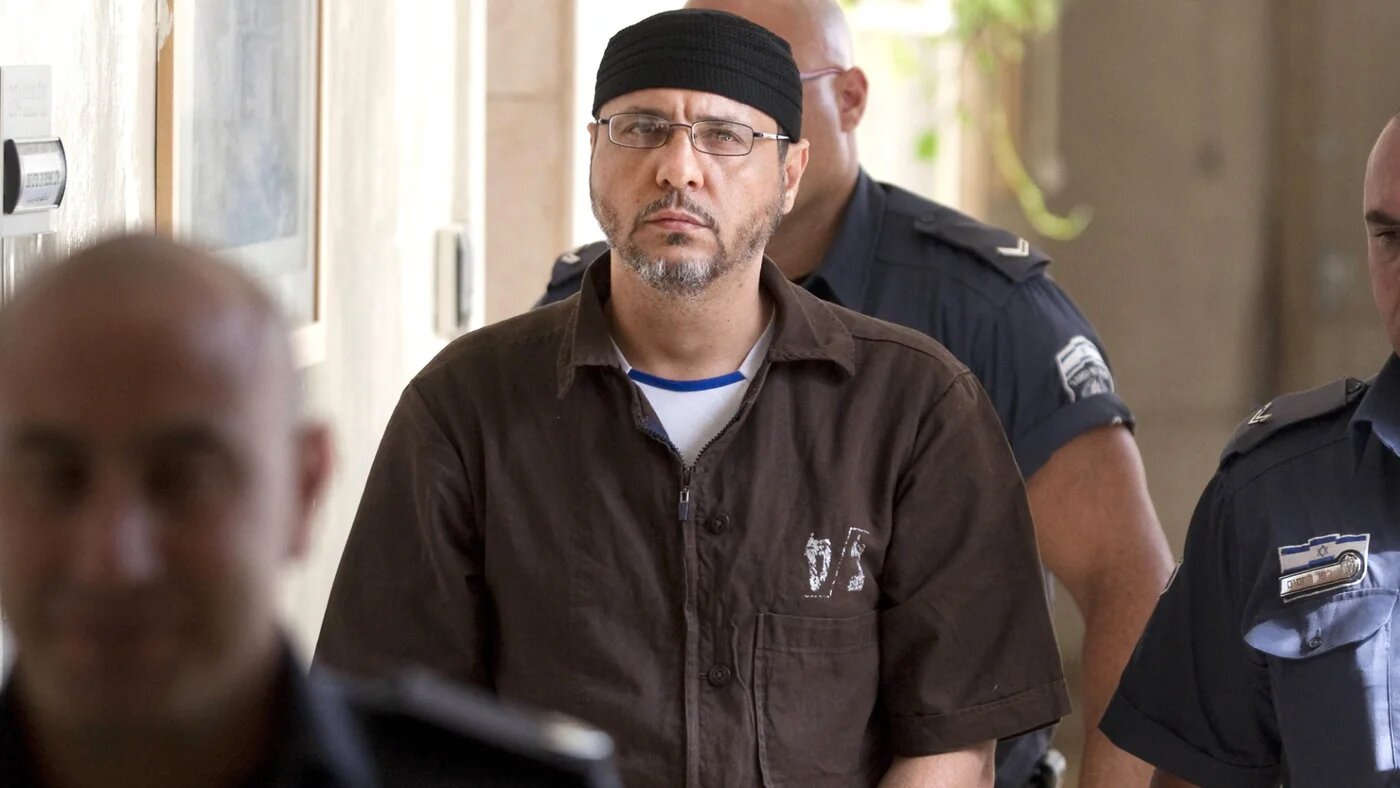 Palestinian Abdullah Barghouti is escorted by Israeli police into the Magistrate Court for a hearing in Jerusalem on 20 June 2012 (AFP/Menahem Kahana)