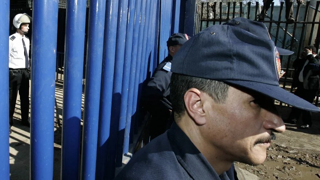 Une photo prise en 2007 montre des douaniers marocains (à droite) tournant le dos à la police espagnole (à gauche) gardant l’entrée de l’enclave nord-africaine espagnole de Melilla (AFP/Abdelhak Senna) 