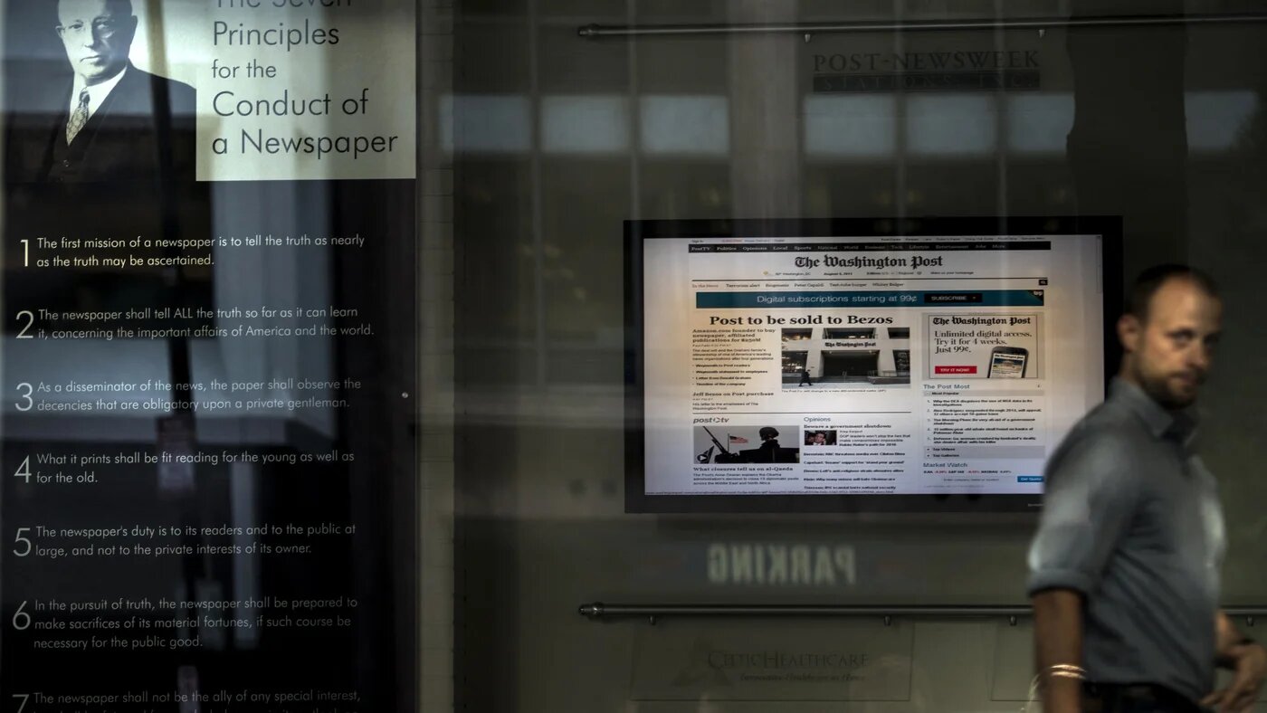 A man walks through the lobby of the Washington Post on 5 August 2013 in Washington, DC (Brendan Smialowski/AFP)